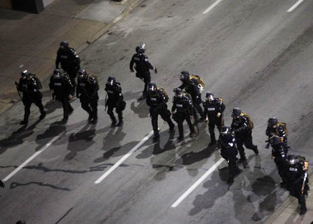 Police officers walk to disperse demonstrators during a protest against the G20 Pittsburgh Summit in Pittsburgh, Pennsylvania September 25, 2009